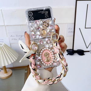 Omio for Samsung Galaxy Z Flip 4 Bling Case with Hand Chain Wrist Strap Bracelet Silk Scarf for Girls Women Sparkle Rhinestone Pearl Crystal Glitter Diamond Shockproof Cover for Galaxy Z Flip 4 Pink